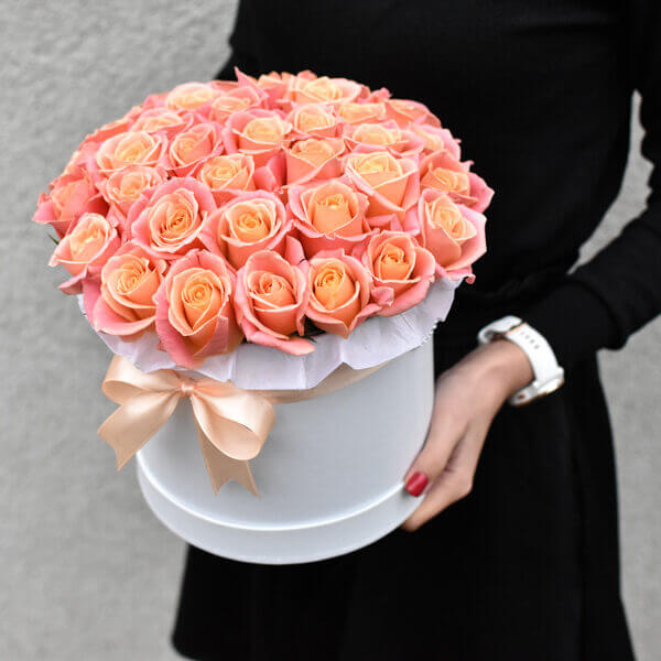 Flowers for a girl in a box of coral roses